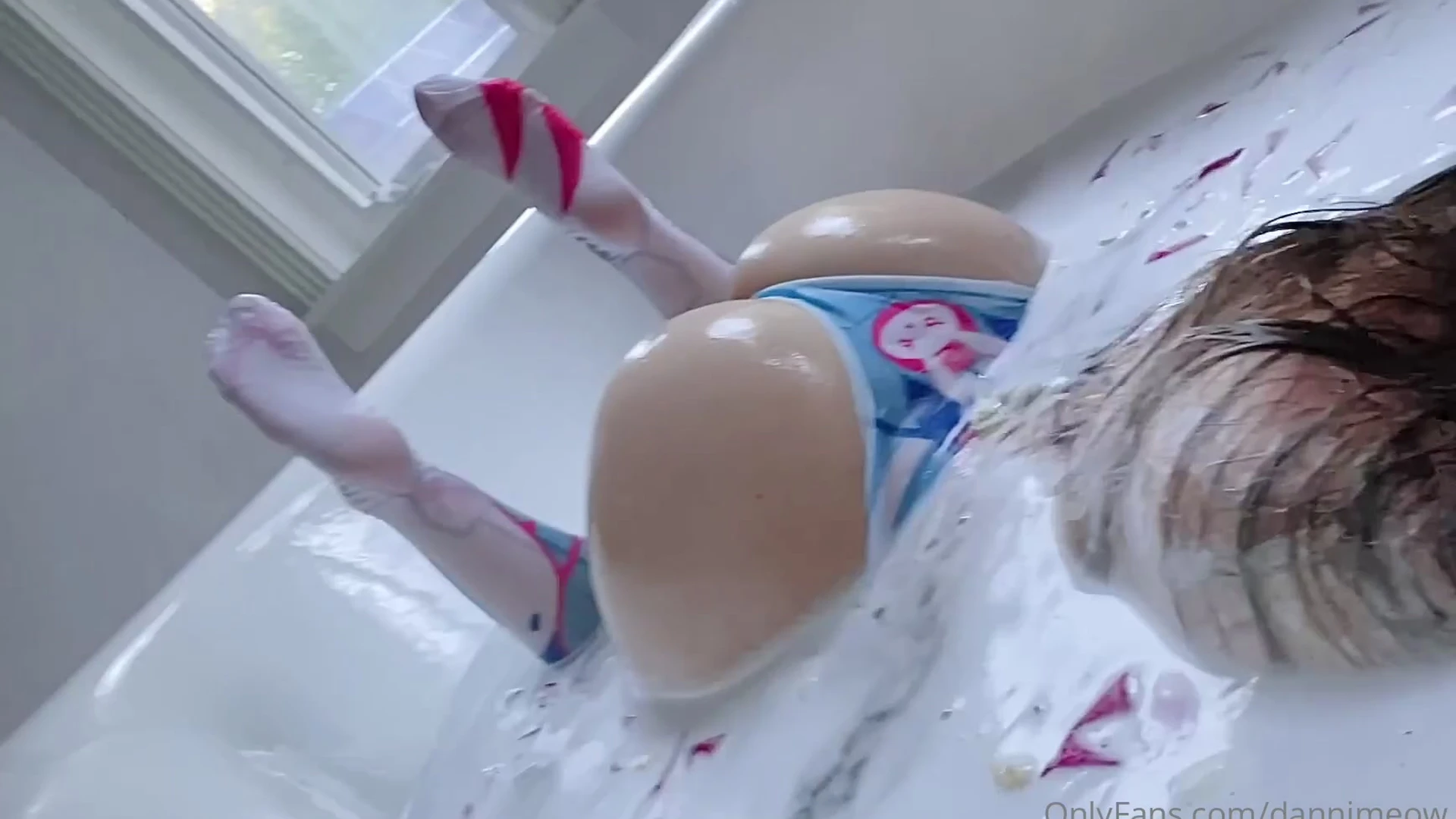 Danni Meow in the bath tub pushing her small ass out