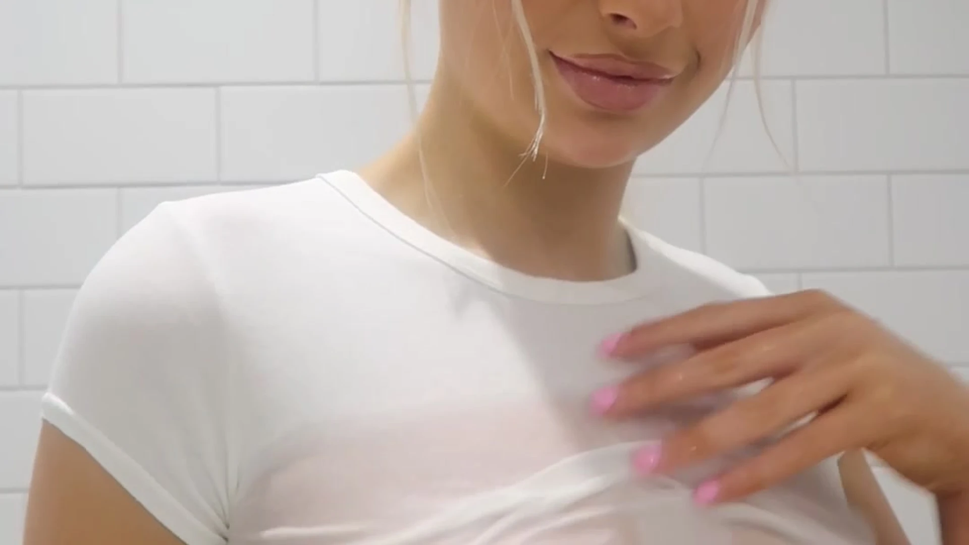 Lillian Phillips in the shower spraying water on her tits